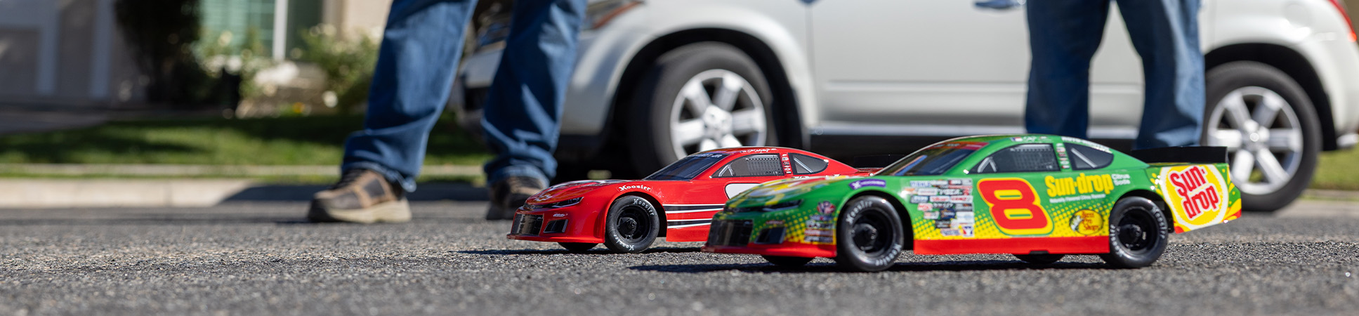 Action shot of a two people driving the Losi 1/12 Asphalt Late Model Dale Earnhardt Jr. No. 8 Ready-to-Run On-Road RC Race Car Action shot of a two people driving the Losi 1/12 Asphalt Late Model Dale Earnhardt Jr. No. 8 Ready-to-Run On-Road RC Race Car